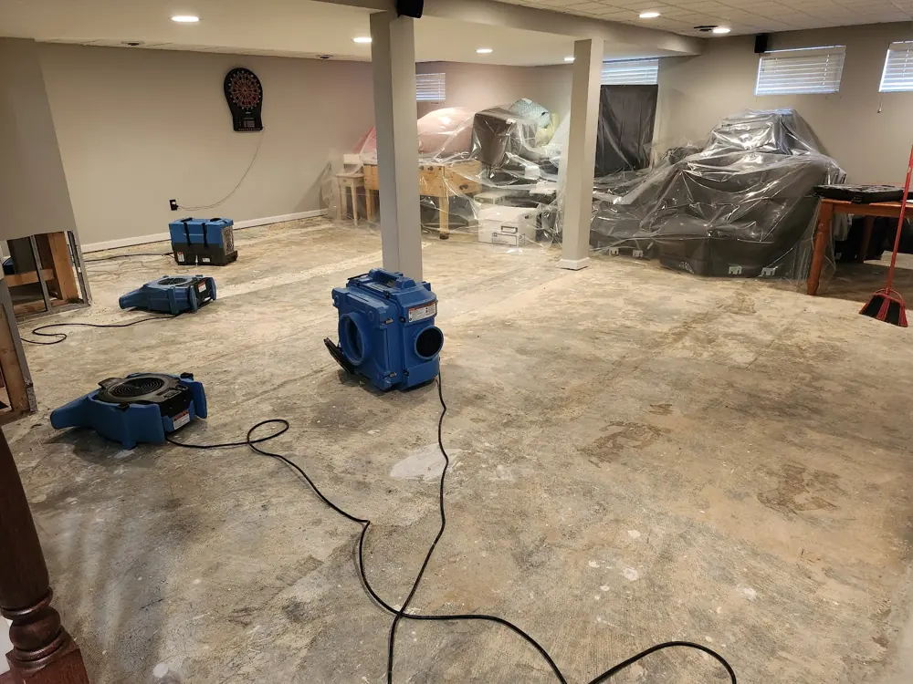 Air movers drying a gutted Aurora room after major water damage